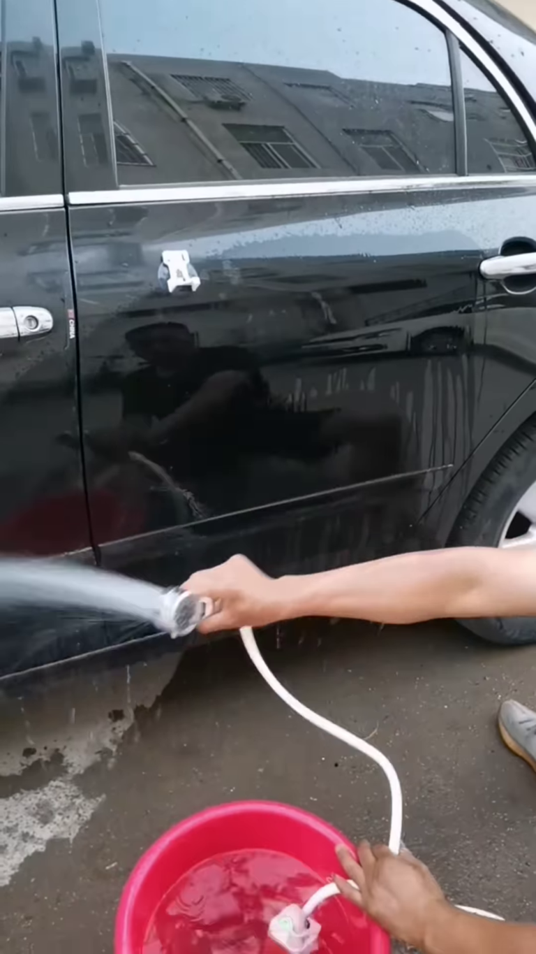 portable car washer with adjustable spray nozzle and integrated soap dispenser